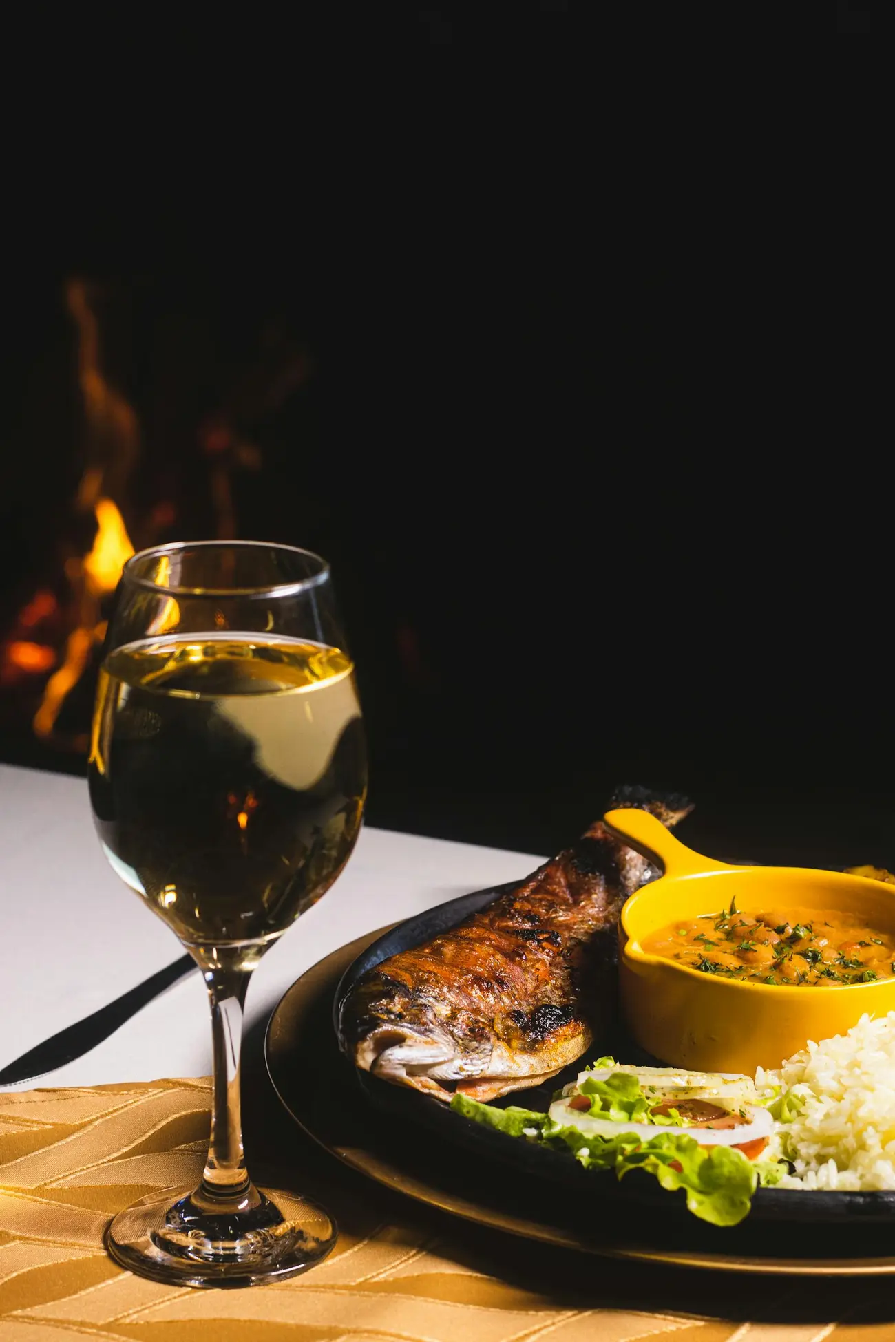 Whole grilled fish with white wine by the fire at Harbor House