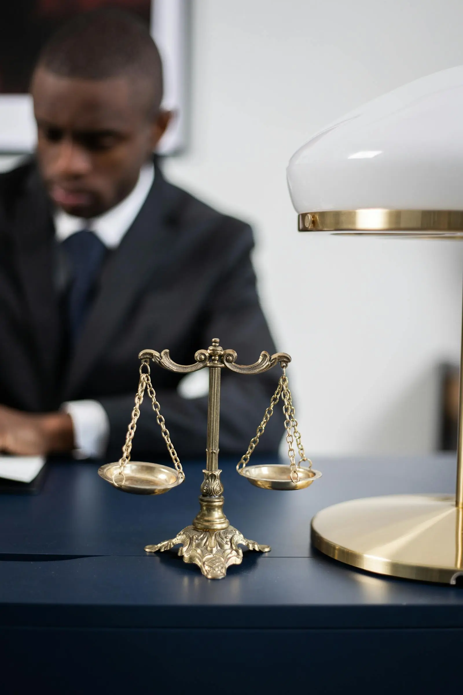 Scales of justice on an attorney's desk at Hartman & Cole