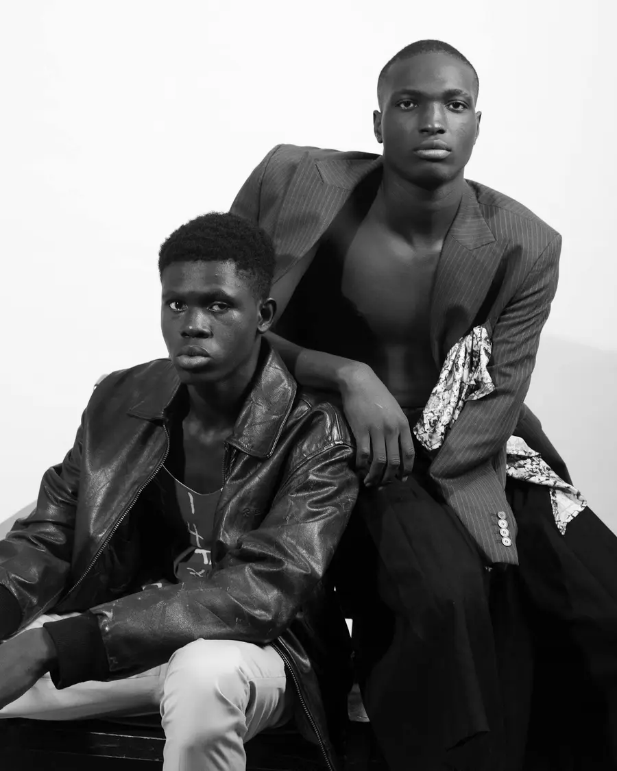 Black and white editorial fashion portrait of two models